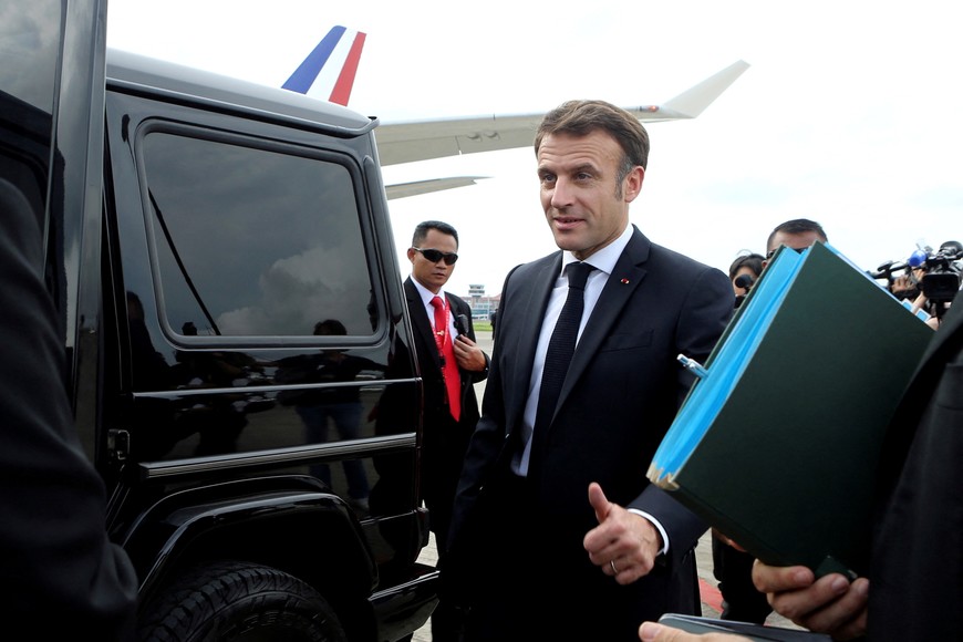 French President Emmanuel Macron gives a thumb up sign as he prepares to board his car upon arrival at Ngurah Rai International Airport ahead of the G20 Summit in Bali, Indonesia, Monday, Nov. 14, 2022. Firdia Lisnawati/Pool via REUTERS