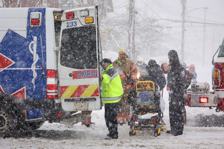 Emergency crews transport an ill patient during a snowstorm as extreme winter weather hits Buffalo, New York, U.S., November 18, 2022.  REUTERS/Lindsay DeDario