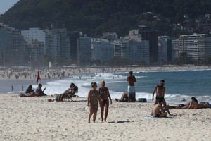 People enjoy Copacabana beach, amid the outbreak of the coronavirus disease (COVID-19), in Rio de Janeiro, Brazil August 9, 2020. REUTERS/Ian Cheibub