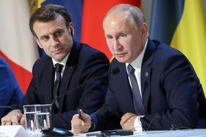 FILE PHOTO: French President Emmanuel Macron and Russian President Vladimir Putin give a press conference after a summit on Ukraine at the Elysee Palace in Paris, December 9, 2019.  Ludovic Marin/Pool via REUTERS/File Photo