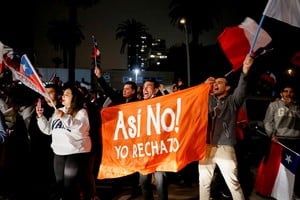 Supporters of "I Reject" option hold a banner that reads "Not like that! I Reject" as they react to early results of the referendum on a new Chilean constitution in Valparaiso, Chile, September 4, 2022. REUTERS/Rodrigo Garrido
