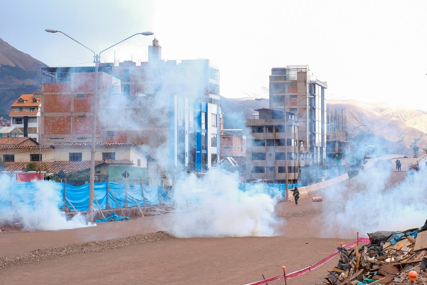 Members of security forces launched tear gases during a clash with protesters near the airport in Cuzco, as they protest demanding the dissolution of the Congress and to hold democratic elections rather than recognizing Dina Boluarte as Peru's President, after the ouster of Peruvian leader Pedro Castillo, in Cuzco, Peru December 14, 2022. REUTERS/Paul Gambin NO RESALES. NO ARCHIVES