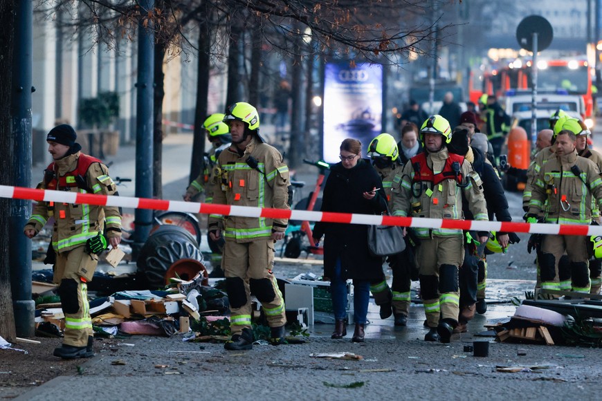 Emergency services work on a street outside a hotel after a leak of the AquaDom aquarium in central Berlin near Alexanderplatz, with water poured out onto the street, in Berlin, Germany, December 16, 2022. REUTERS/Michele Tantussi