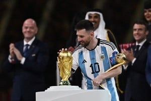 Soccer Football - FIFA World Cup Qatar 2022 - Final - Argentina v France - Lusail Stadium, Lusail, Qatar - December 18, 2022 
Argentina's Lionel Messi touches the World Cup trophy after receiving the Golden Ball award REUTERS/Dylan Martinez