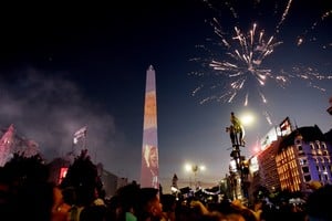 Soccer Football - FIFA World Cup Final Qatar 2022 - Fans in Buenos Aires - Buenos Aires, Argentina - December 18, 2022 
Argentina fans celebrate winning the World Cup at the Obelisk with an image of Lionel Messi and fireworks REUTERS/Mariana Nedelcu