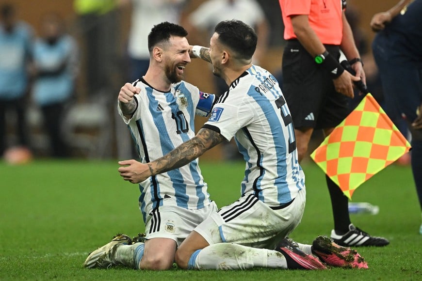 Soccer Football - FIFA World Cup Qatar 2022 - Final - Argentina v France - Lusail Stadium, Lusail, Qatar - December 18, 2022
Argentina's Lionel Messi celebrates with Leandro Paredes after winning the World Cup REUTERS/Dylan Martinez
