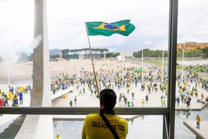 A man waves Brazil's flag as supporters of Brazil's former President Jair Bolsonaro demonstrate against President Luiz Inacio Lula da Silva, outside Brazil’s National Congress in Brasilia, Brazil, December 8, 2023. REUTERS/Adriano Machado
