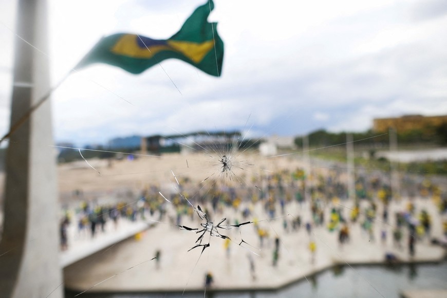 A demonstration held by supporters of Brazil's former President Jair Bolsonaro against President Luiz Inacio Lula da Silva is pictured through a broken window in Brasilia, Brazil, December 8, 2023. REUTERS/Adriano Machado
