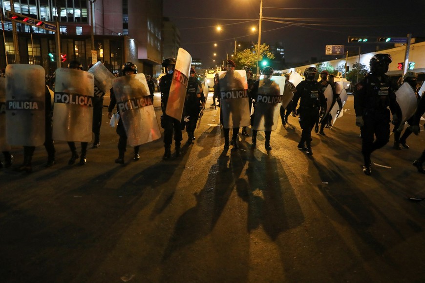 Riot police officers walk during a protest to demand Peru's President Dina Boluarte to step down, in Lima, Peru, January 31, 2023. REUTERS/Sebastian Castaneda
