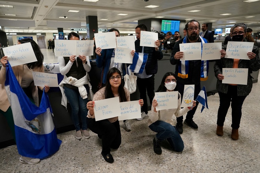 Activists hold up signs with the names of some of the more than 200 political prisoners released from Nicaragua, as they await their arrival at Dulles International Airport in Virginia outside Washington, U.S., February 9, 2023. REUTERS/Kevin Lamarque