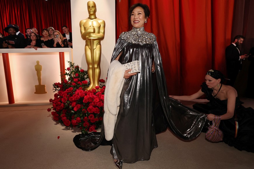 Janet Yang poses on the champagne-colored red carpet during the Oscars arrivals at the 95th Academy Awards in Hollywood, Los Angeles, California, U.S., March 12, 2023. REUTERS/Mario Anzuoni