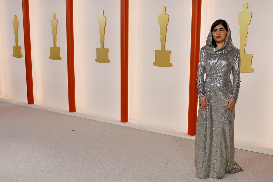 Malala Yousafzai poses on the champagne-colored red carpet during the Oscars arrivals at the 95th Academy Awards in Hollywood, Los Angeles, California, U.S., March 12, 2023. REUTERS/Eric Gaillard