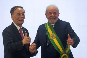 FILE PHOTO: Brazil's President Luiz Inacio Lula da Silva reacts with China's Vice President Wang Qishan, in Brasilia, Brazil, January 1, 2023. REUTERS/Ricardo Moraes/File Photo