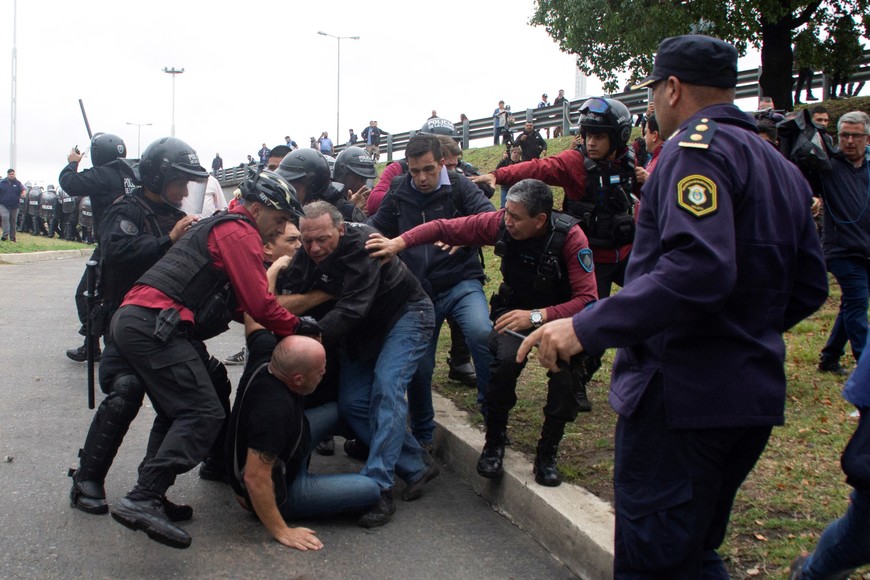 Buenos Aires' Province Security Minister Sergio Berni is protected by police officers after being assaulted by bus drivers who were protesting the murder of a colleague, in Buenos Aires, Argentina April 3, 2023. REUTERS/Andres Pelozo NO RESALES. NO ARCHIVES