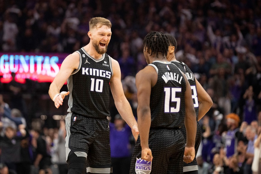 April 17, 2023; Sacramento, California, USA; Sacramento Kings forward Domantas Sabonis (10) celebrates with guard Davion Mitchell (15) against the Golden State Warriors during the second quarter in game two of the second round of the 2023 NBA playoffs at Golden 1 Center. Mandatory Credit: Kyle Terada-USA TODAY Sports