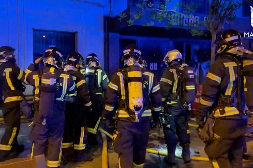 Firefighters gather outside a restaurant following a fire, in Madrid, Spain, April 21, 2023, in this screen grab taken from a handout video. Madrid Emergency Service/Handout via REUTERS  THIS IMAGE HAS BEEN SUPPLIED BY A THIRD PARTY