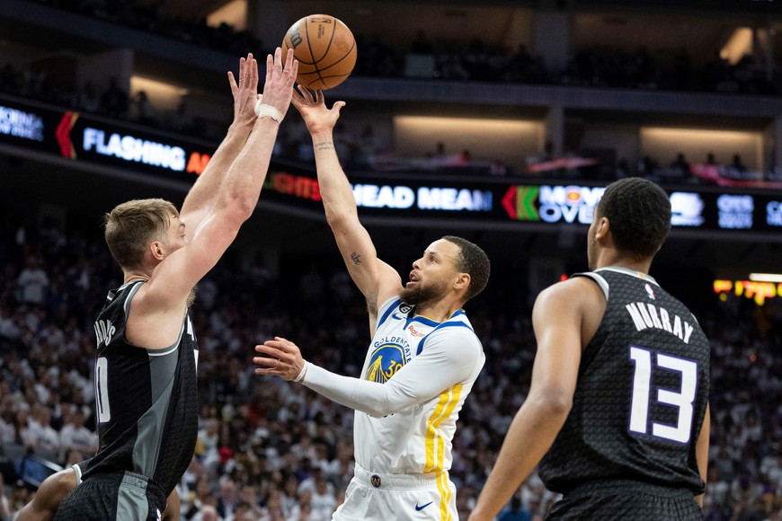 April 30, 2023; Sacramento, California, USA; Golden State Warriors guard Stephen Curry (30) shoots the basketball against Sacramento Kings forward Domantas Sabonis (10) and forward Keegan Murray (13) during the third quarter in game seven of the 2023 NBA playoffs first round at Golden 1 Center. Mandatory Credit: Kyle Terada-USA TODAY Sports