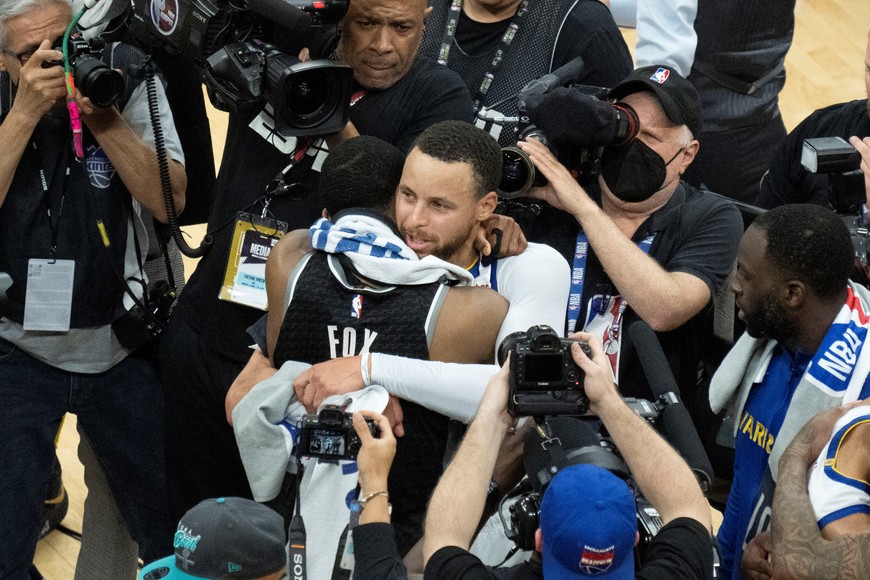 April 30, 2023; Sacramento, California, USA; Golden State Warriors guard Stephen Curry (30) hugs Sacramento Kings guard De'Aaron Fox (5) after game seven of the 2023 NBA playoffs first round at Golden 1 Center. Mandatory Credit: Kyle Terada-USA TODAY Sports