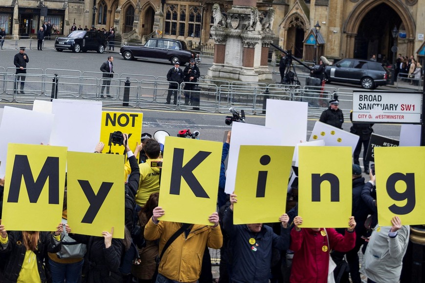 Britain's King Charles and Camilla, Queen Consort travel in a car while anti-monarchy protesters gather prior to the Commonwealth Service, outside Westminster Abbey in London, Britain, March 13, 2023. REUTERS/May James

     TPX IMAGES OF THE DAY