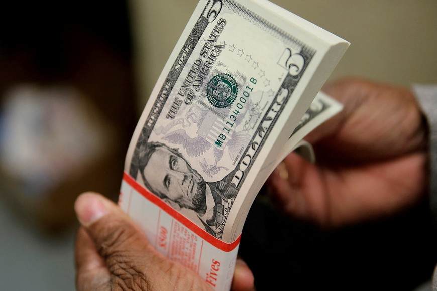 FILE PHOTO: A packet of U.S. five-dollar bills is inspected at the Bureau of Engraving and Printing in Washington March 26, 2015. REUTERS/Gary Cameron/File Photo