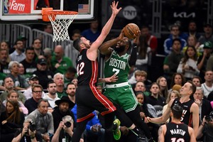 May 25, 2023; Boston, Massachusetts, USA; Boston Celtics guard Jaylen Brown (7) shoots against Miami Heat forward Kevin Love (42) in the fourth quarter during game five of the Eastern Conference Finals for the 2023 NBA playoffs at TD Garden. Mandatory Credit: Brian Fluharty-USA TODAY Sports