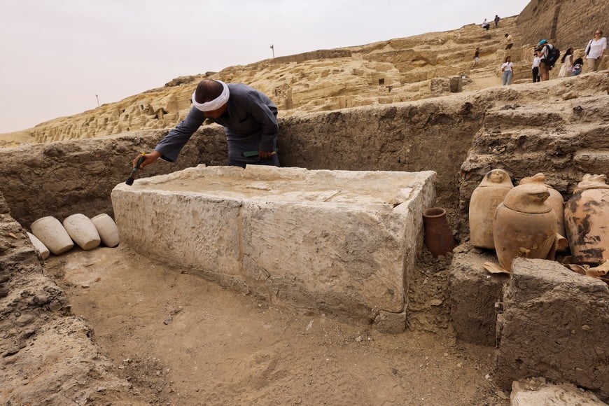 A worker brushes off the dust at the embalming workshop site for humans at the newly discovered site where two embalming workshops for humans and animals, two tombs and a collection of artefacts were also found, near Egypt's Saqqara necropolis, in Giza, Egypt May 27, 2023. REUTERS/Amr Abdallah Dalsh