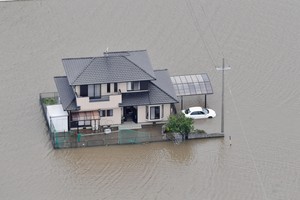 A house surrounded by floodwaters following heavy rain brought about by Typhoon Mawar is pictured from a Kyodo News helicopter in Toyokawa, Aichi Prefecture, central Japan in this photo taken by Kyodo on June 3, 2023.  Mandatory credit Kyodo/via REUTERS ATTENTION EDITORS - THIS IMAGE WAS PROVIDED BY A THIRD PARTY. MANDATORY CREDIT. JAPAN OUT. NO COMMERCIAL OR EDITORIAL SALES IN JAPAN
