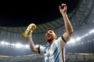 FILE PHOTO: Soccer Football - FIFA World Cup Qatar 2022 - Final - Argentina v France - Lusail Stadium, Lusail, Qatar - December 18, 2022 
 Argentina's Lionel Messi celebrates winning the World Cup with the trophy REUTERS/Hannah Mckay/File Photo