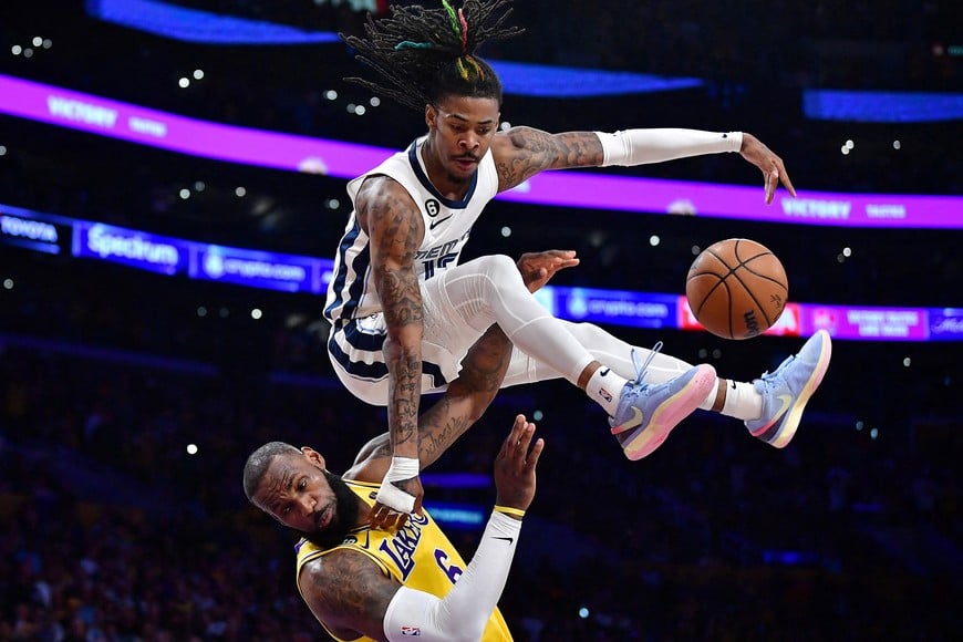 Apr 24, 2023; Los Angeles, California, USA; Memphis Grizzlies guard Ja Morant (12) collides with Los Angeles Lakers forward LeBron James (6) while moving to the basket during the second half in game four of the 2023 NBA playoffs at Crypto.com Arena. Mandatory Credit: Gary A. Vasquez-USA TODAY Sports     TPX IMAGES OF THE DAY