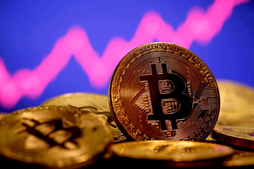 FILE PHOTO: A representation of virtual currency Bitcoin is seen in front of a stock graph in this illustration taken January 8, 2021. REUTERS/Dado Ruvic/File Photo