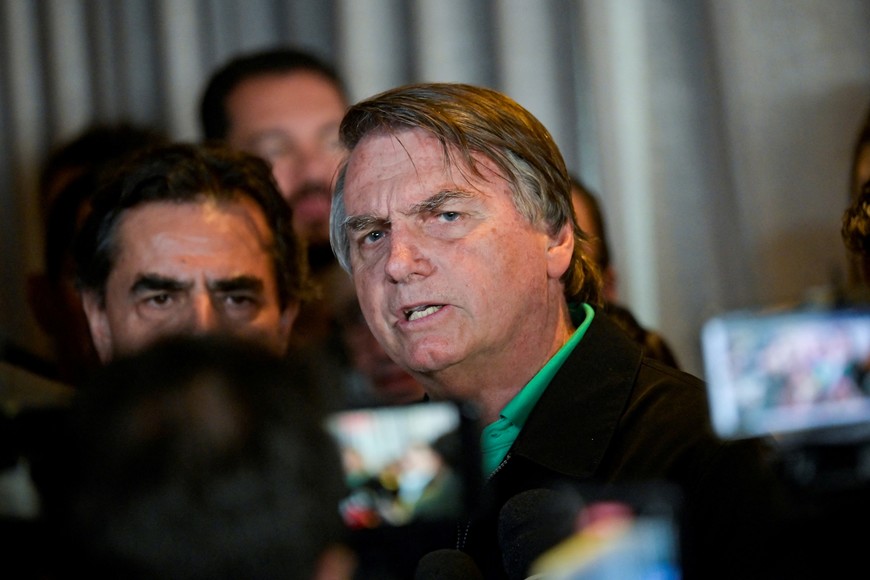 Brazil's former President Jair Bolsonaro talks with media at a restaurant, on the day the Electoral Justice continues the trial to determine his political rights, in Belo Horizonte, Brazil June 30, 2023. REUTERS/Washington Alves