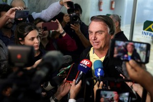 FILE PHOTO: Brazil's former President Jair Bolsonaro speaks with media as he arrives at the airport in Rio de Janeiro, on the day the Electoral Justice continues the trial to determine his political rights, Brazil June 29, 2023. REUTERS/Pilar Olivares/File Photo