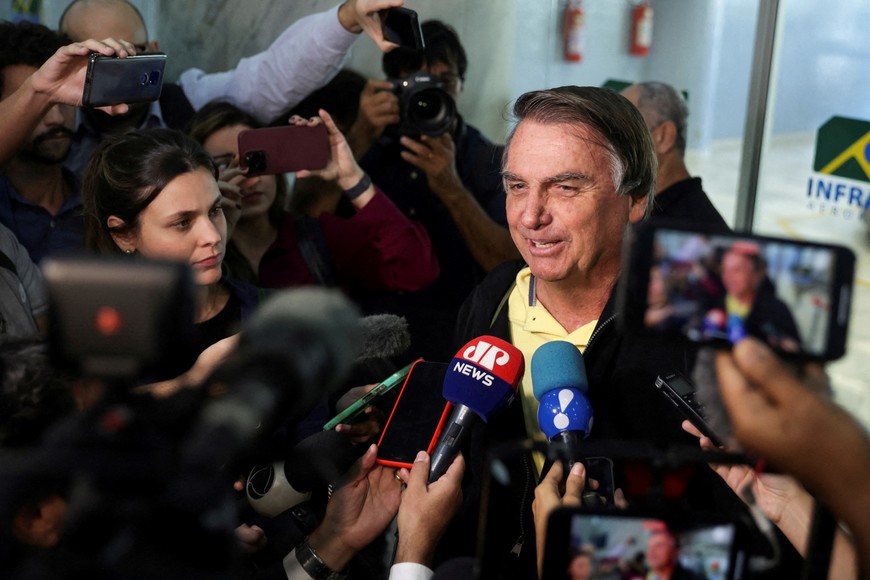 FILE PHOTO: Brazil's former President Jair Bolsonaro speaks with media as he arrives at the airport in Rio de Janeiro, on the day the Electoral Justice continues the trial to determine his political rights, Brazil June 29, 2023. REUTERS/Pilar Olivares/File Photo