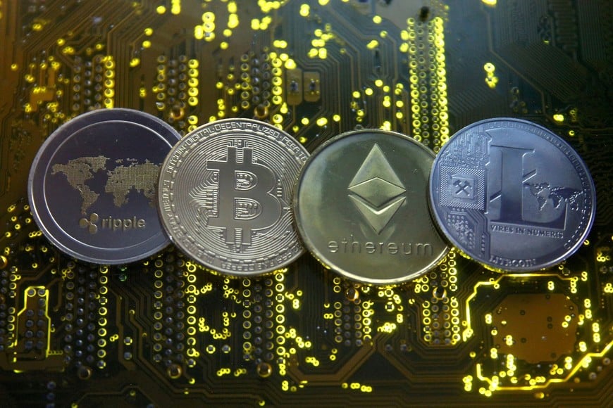 FILE PHOTO: Representations of the Ripple, bitcoin, etherum and Litecoin virtual currencies are seen on a PC motherboard in this illustration picture, February 14, 2018. REUTERS/Dado Ruvic/File Photo