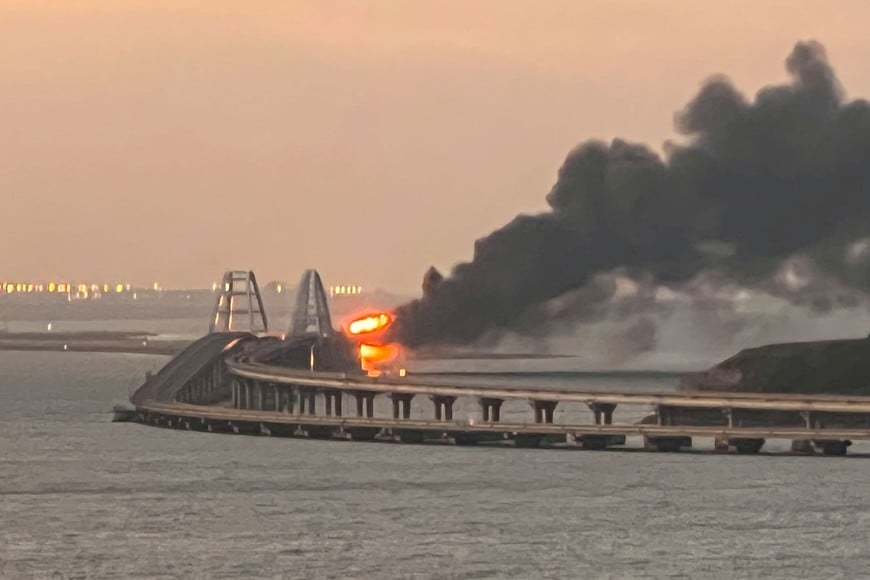 A view shows a fire on the Kerch bridge at sunrise in the Kerch Strait, Crimea, October 8, 2022.  REUTERS/Stringer      TPX IMAGES OF THE DAY