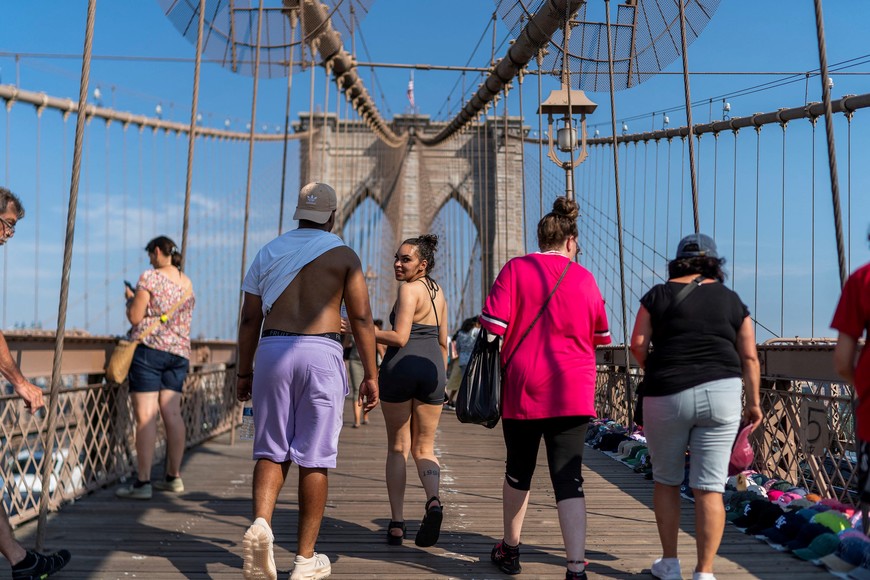People visit the Brooklyn Bridge during hot weather in New York City, U.S., July 13, 2023. REUTERS/Eduardo Munoz