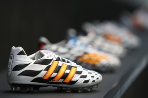 Adidas soccer shoes are pictured before the company's news conference in the northern Bavarian town of Herzogenaurach, near Nuremberg in this June 24, 2014 file photo.  Adidas might be attracting bad online buzz for its sponsorship of biting Uruguayan footballer Luis Suarez - but in the tussle to win the most World Cup social media play, the German firm says it is winning plenty of positive attention too. With every tackle, save and goal, a simultaneous off-the-pitch marketing battle is being fought between official FIFA World Cup sponsor Adidas and arch-rival to dominate social media to promote their brands.  REUTERS/Michaela Rehle/Files (GERMANY - Tags: SPORT SOCCER BUSINESS WORLD CUP) alemania  botines de futbol de la marca adidas presentacion nuevos botines zapatillas botines