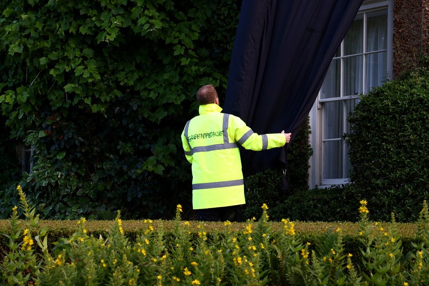 A Greenpeace activist covers British Prime Minister Rishi Sunak's £2m manor house with oil-black fabric in protest of his backing for a major expansion of North Sea oil and gas drilling amidst a summer of escalating climate impacts, in Yorkshire, Britain August 3, 2023. Greenpeace/Handout via REUTERS    THIS IMAGE HAS BEEN SUPPLIED BY A THIRD PARTY. NO RESALES. NO ARCHIVES. MANDATORY CREDIT. NO USE AFTER AUGUST 17, 2023.