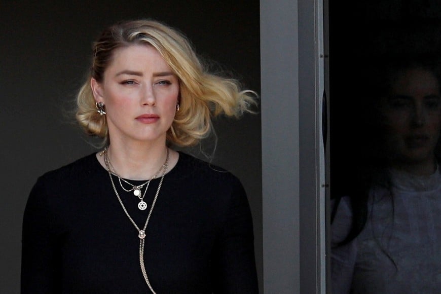 Amber Heard leaves Fairfax County Circuit Courthouse after the jury announced split verdicts in favor of both her ex-husband Johnny Depp and Heard on their claim and counter-claim in the Depp v. Heard civil defamation trial at the Fairfax County Circuit Courthouse in Fairfax, Virginia, U.S., June 1, 2022. REUTERS/Tom Brenner