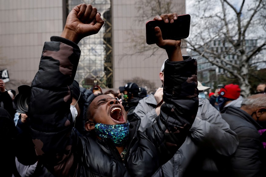 A person reacts after the verdict in the trial of former Minneapolis police officer Derek Chauvin, found guilty of the death of George Floyd, in front of Hennepin County Government Center, in Minneapolis, Minnesota, U.S., April 20, 2021. REUTERS/Carlos Barria/File Photo     TPX IMAGES OF THE DAY SEARCH "GLOBAL POY" FOR THIS STORY. SEARCH "REUTERS POY" FOR ALL BEST OF 2021 PACKAGES.