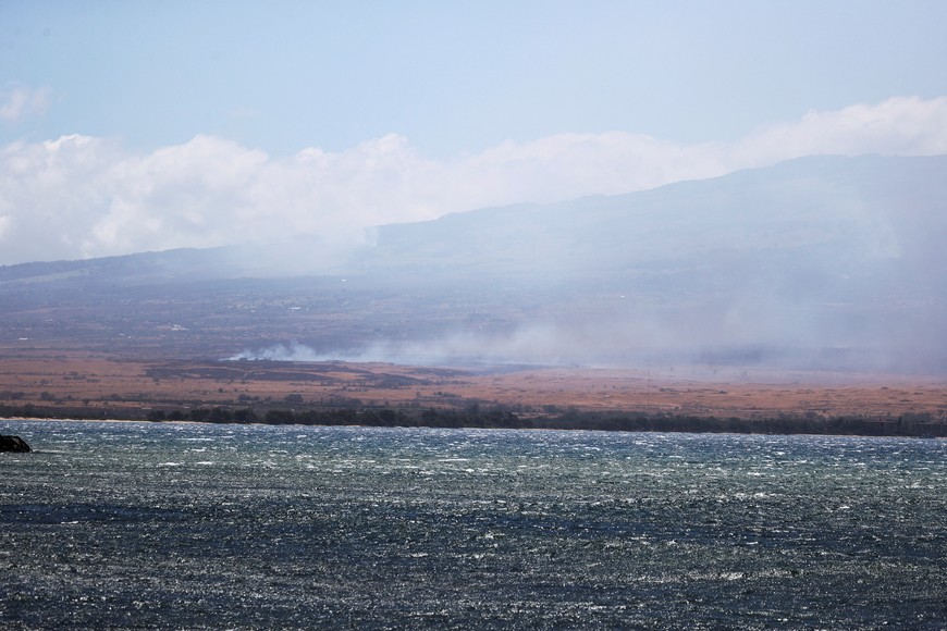 Wildfires are seen across Maalaea Harbor due to high winds in Maui believed to have destroyed a large part of the historic town of Lahaina, in Kahului, Hawaii, U.S. August 9, 2023. REUTERS/Marco Garcia