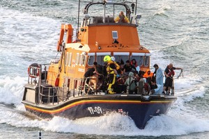 Rescue personnel bring migrants ashore, after a boat carrying migrants from France sunk in the English Channel, in Dover, Britain August 12, 2023, in this still image obtained from social media. Stuart Brock/via REUTERS  THIS IMAGE HAS BEEN SUPPLIED BY A THIRD PARTY. MANDATORY CREDIT.