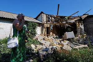 Lyubov Tolchina, 63, reacts next to the damaged house of her son Vitaly, 40, who was killed the day before by shelling in the course of Russia-Ukraine conflict in Donetsk, Russian-controlled Ukraine, August 13, 2023. REUTERS/Alexander Ermochenko