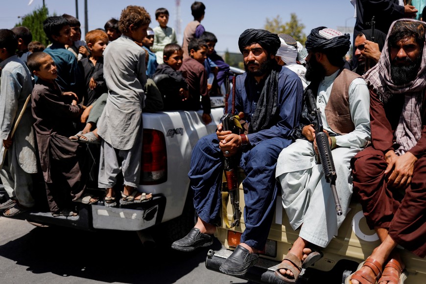 Taliban soldiers celebrate on the second anniversary of the fall of Kabul on a street near the US embassy in Kabul, Afghanistan, August 15, 2023. REUTERS/Ali Khara