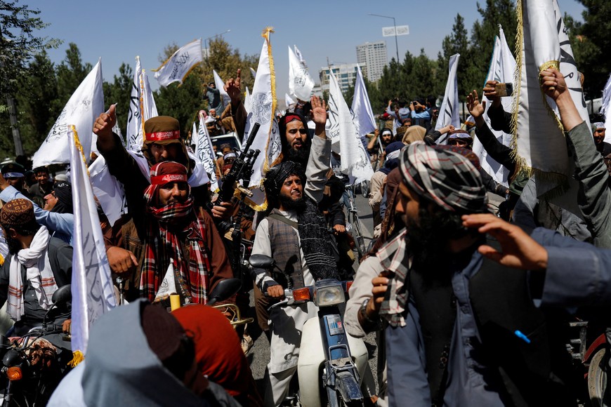 Taliban members celebrate on the second anniversary of the fall of Kabul on a street near the US embassy in Kabul, Afghanistan, August 15, 2023. REUTERS/Ali Khara