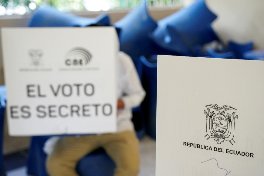 A person casts his vote at a polling station during the presidential election, in Pajan, Manabi, Ecuador August 20, 2023. The words on the ballot box read "Republic of Ecuador" and "The vote is secret". REUTERS/Santiago Arcos