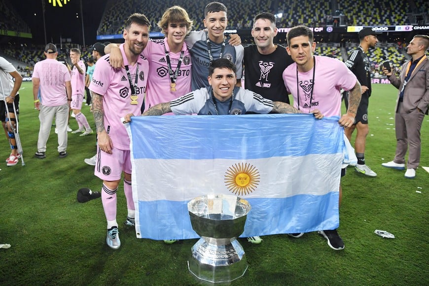 Aug 19, 2023; Nashville, TN, USA; Inter Miami CF forward Lionel Messi (10) pose for a photo with teammates and an Argentina flag after winning the Leagues Cup against Nashville SC at GEODIS Park. Mandatory Credit: Christopher Hanewinckel-USA TODAY Sports