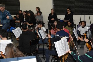 Concierto sinfónico-coral: Manuel Marina dirigiendo la Orquesta Juvenil; bajo el panel de la derecha, Virginia Bono (directora del Coro de Niños del Instituto Coral) y Gauna (directora del Ensamble del Instituto y del Coro de Niños, Niñas y Adolescentes de la UNL).