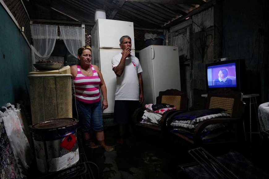 A couple shows to Reuters their flooded home as Storm Idalia makes landfall in Cuba, Guanimar, Cuba, August 28, 2023.  REUTERS/Alexandre Meneghini      TPX IMAGES OF THE DAY