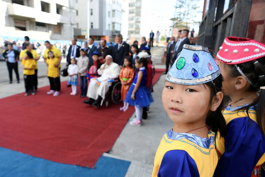 A girl looks on as Pope Francis attends a welcome ceremony at the bishop's house during his Apostolic Journey, in Ulaanbaatar, Mongolia September 1, 2023.    Vatican Media/­Handout via REUTERS    ATTENTION EDITORS - THIS IMAGE WAS PROVIDED BY A THIRD PARTY.